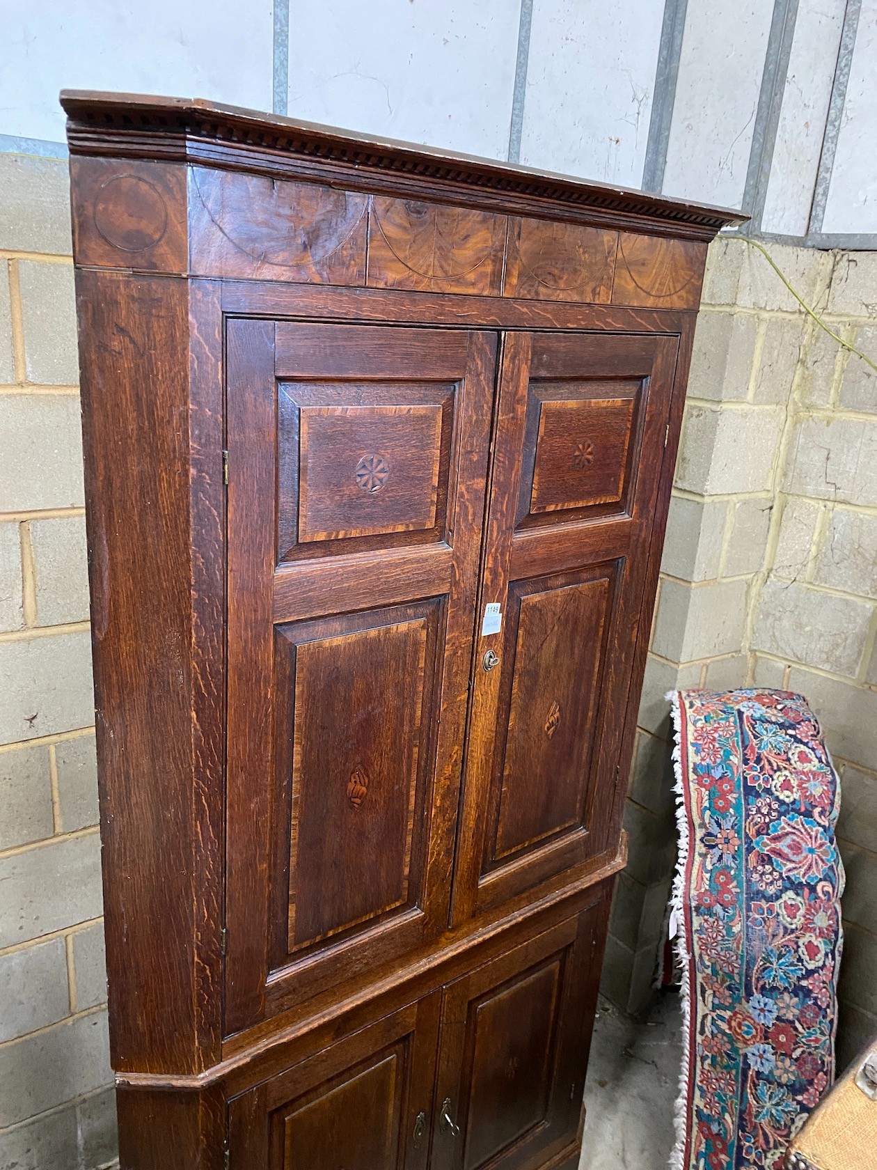 A George III mahogany banded oak standing corner cabinet, width 118cm, depth 64cm, height 224cm